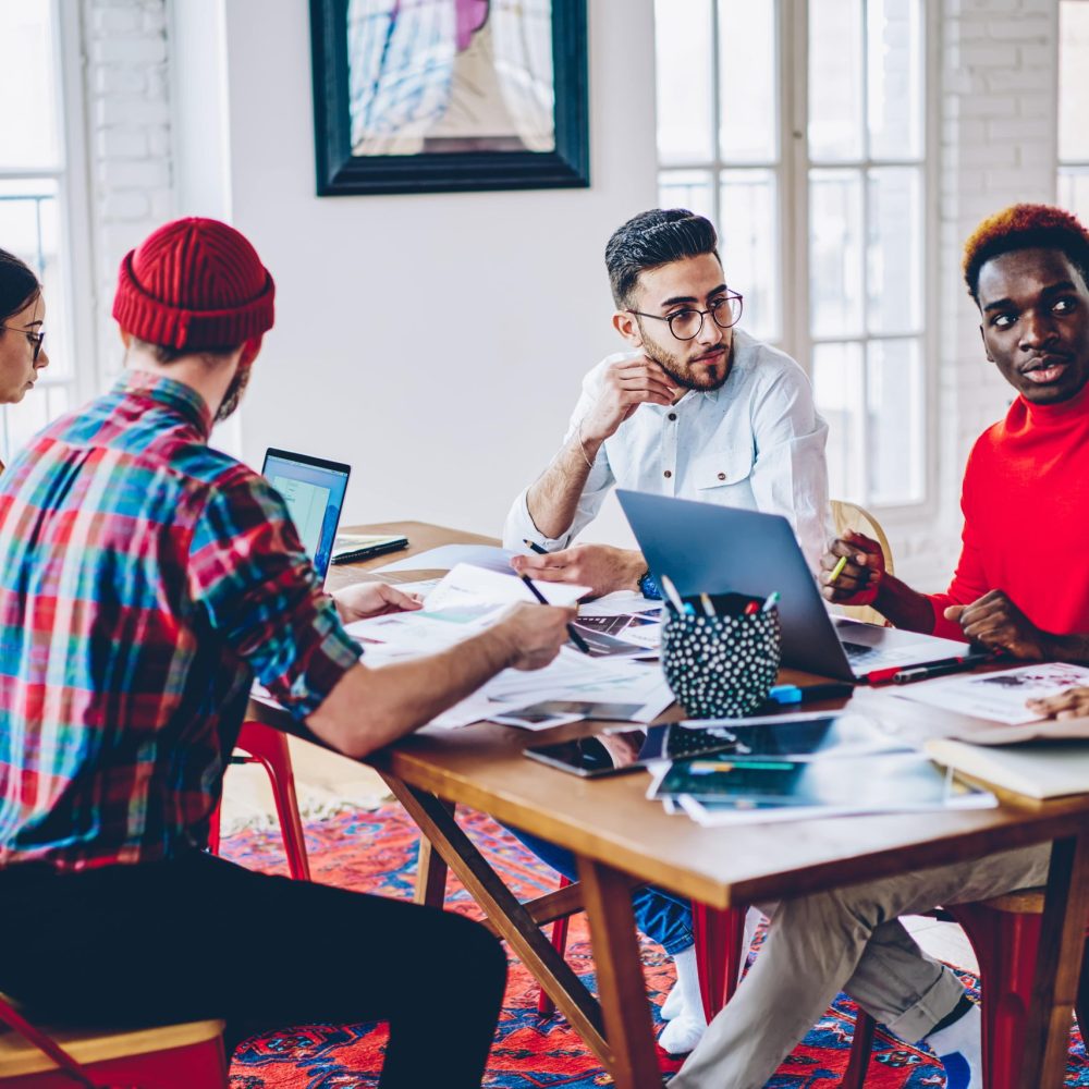 youthful-hipster-coworkers-discussing-developing-p-2023-07-18-18-40-34-utc-min